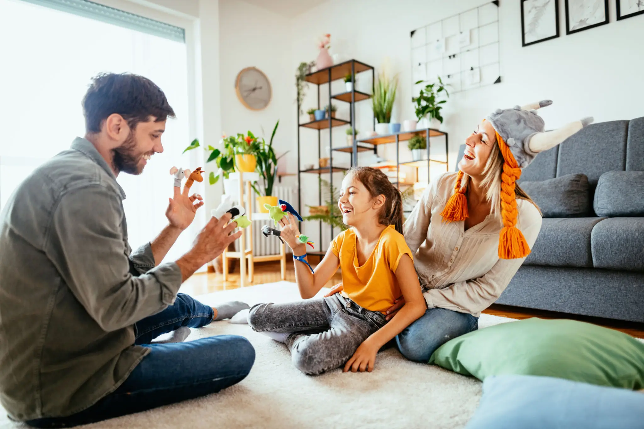 Family enjoying playful time together in a sunny living room.
