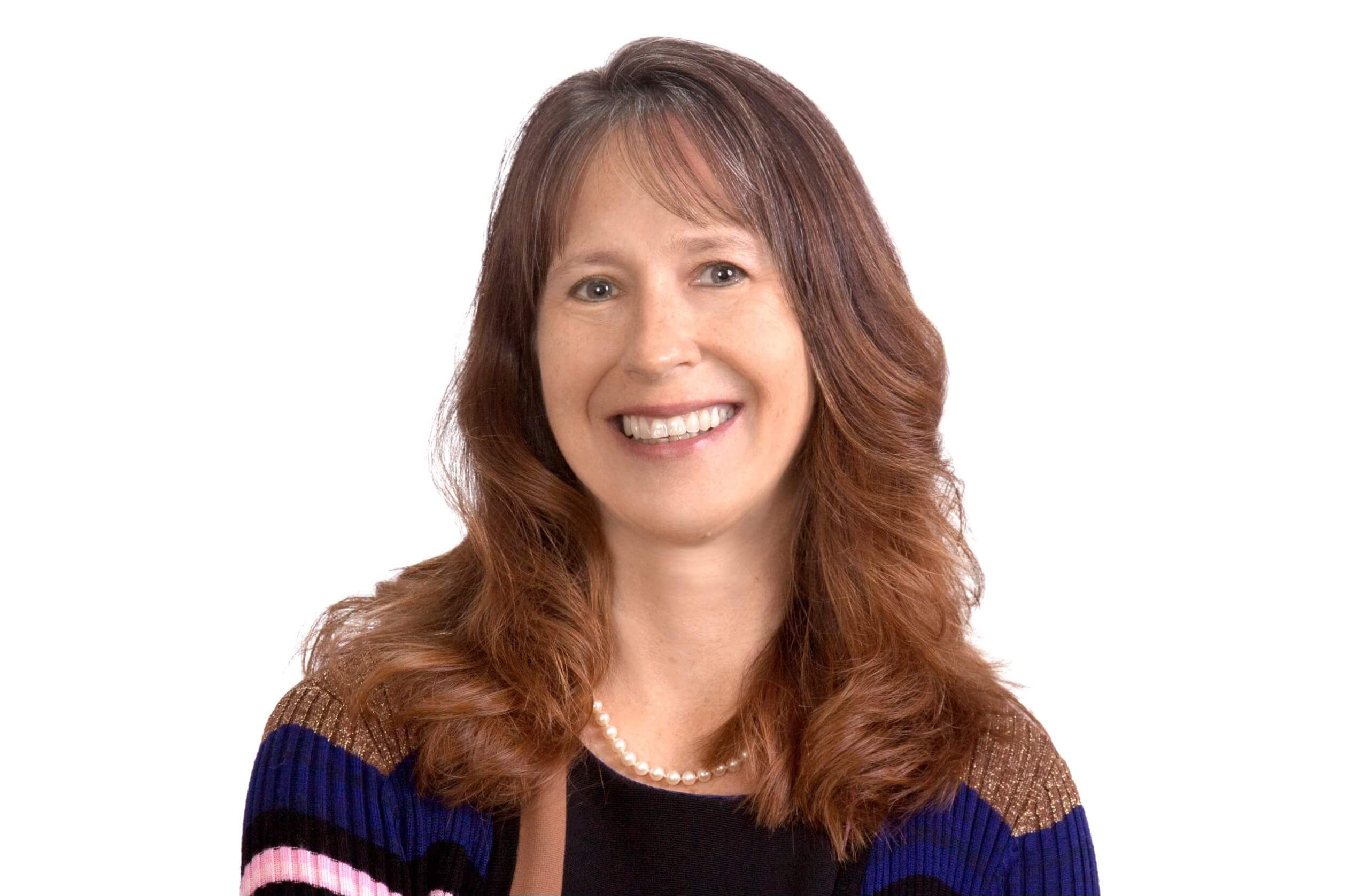 Smiling woman with long brown hair in a dark top.